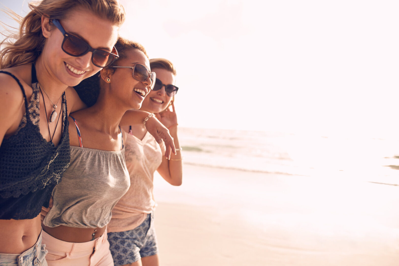 Group,Of,Beautiful,Young,Women,Strolling,On,A,Beach.,Three